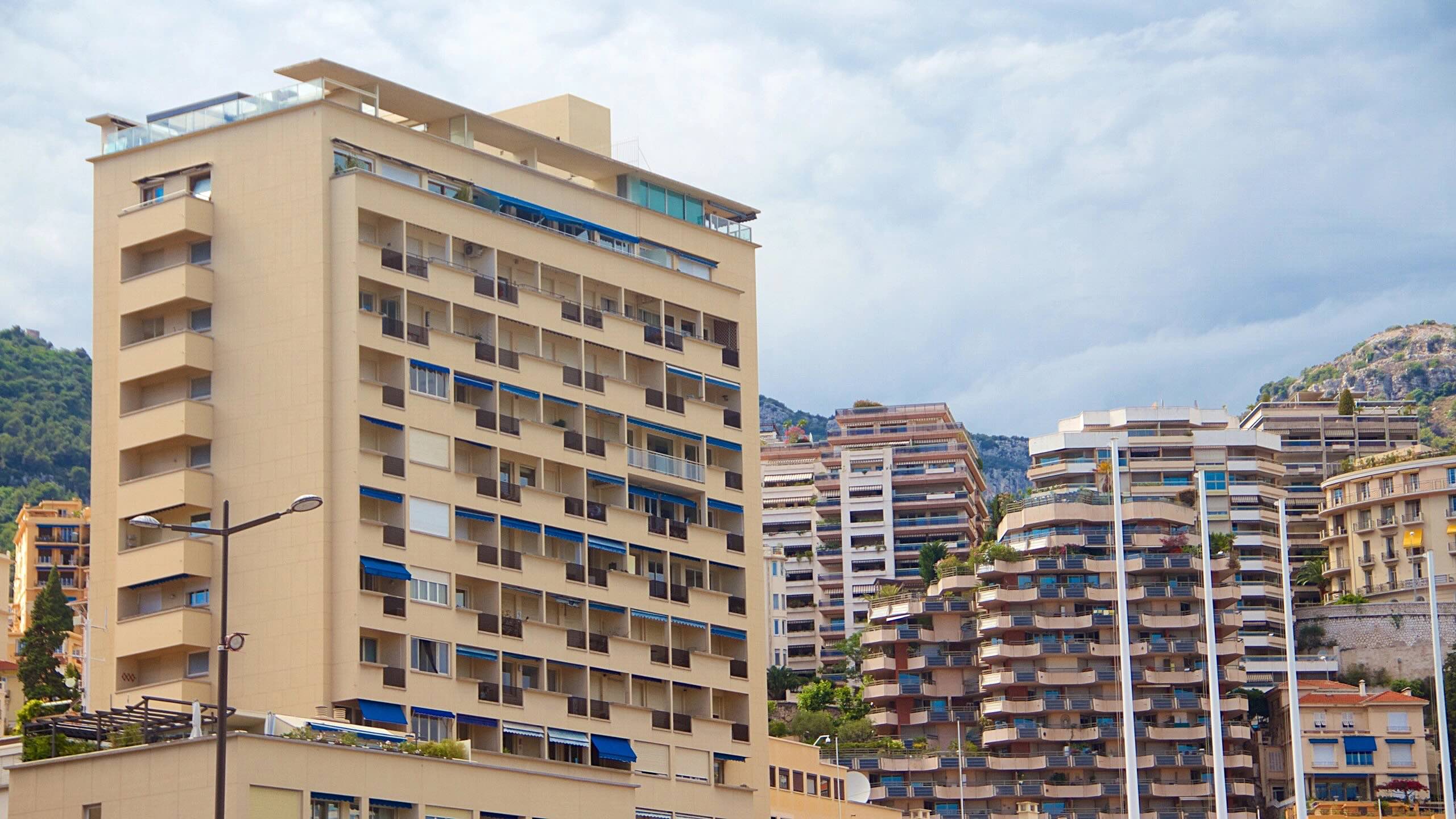 View of Monaco’s Port Hercule from a balcony at Palais Heraclès, offering breathtaking Mediterranean vistas.