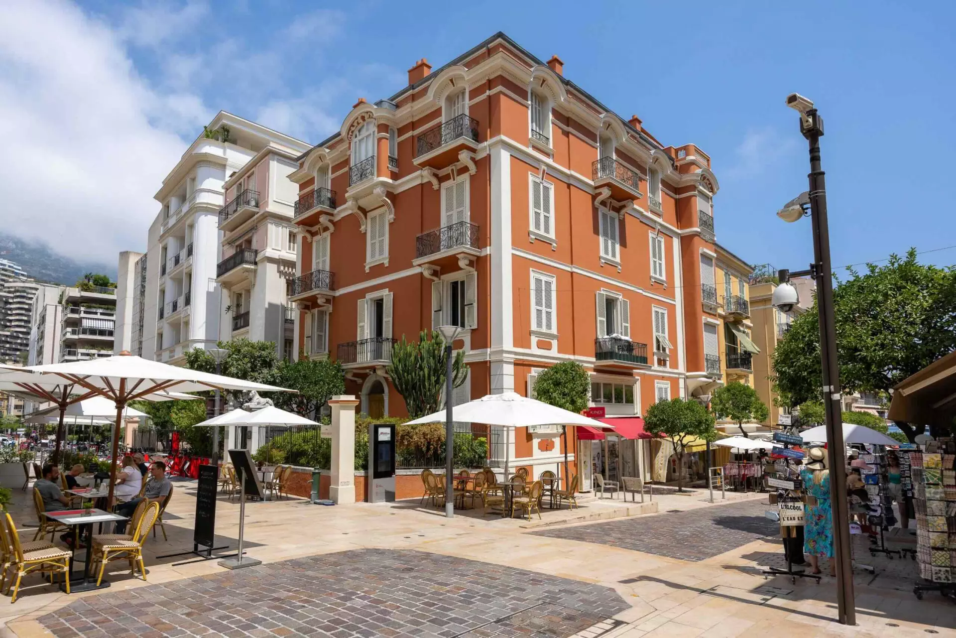 Bustling square in La Condamine with cafés, historic buildings, and local shops in Monaco.