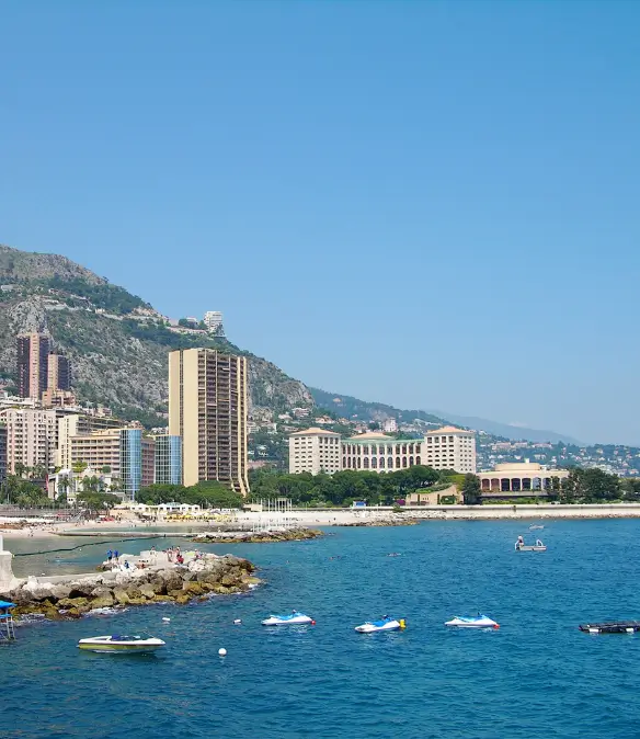Larvotto beach in Monaco with luxury buildings along the coastline