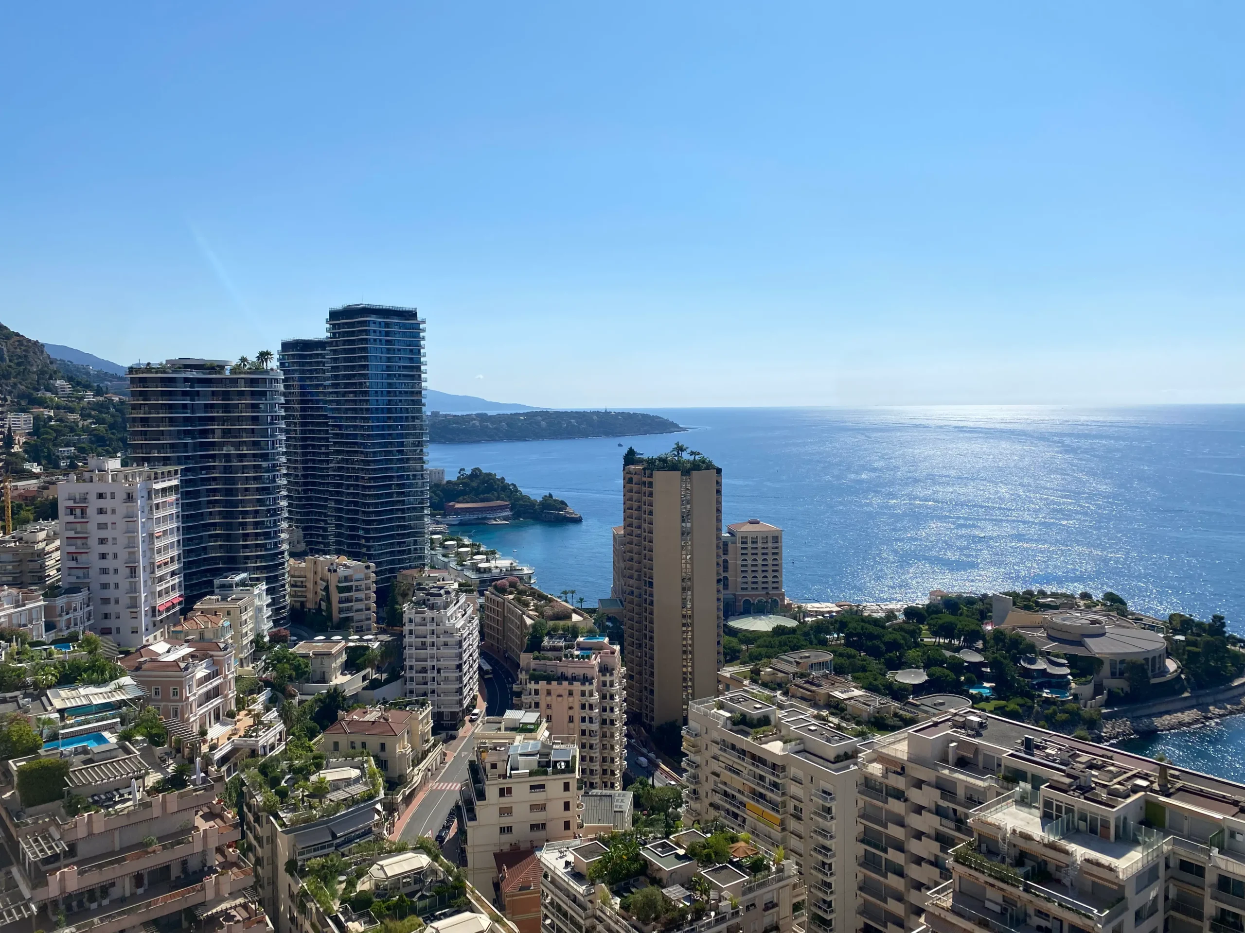 Aerial image of the La Rousse-Saint Roman and Larvotto neighbourhoods in Monaco with the mediterranean sea in the background