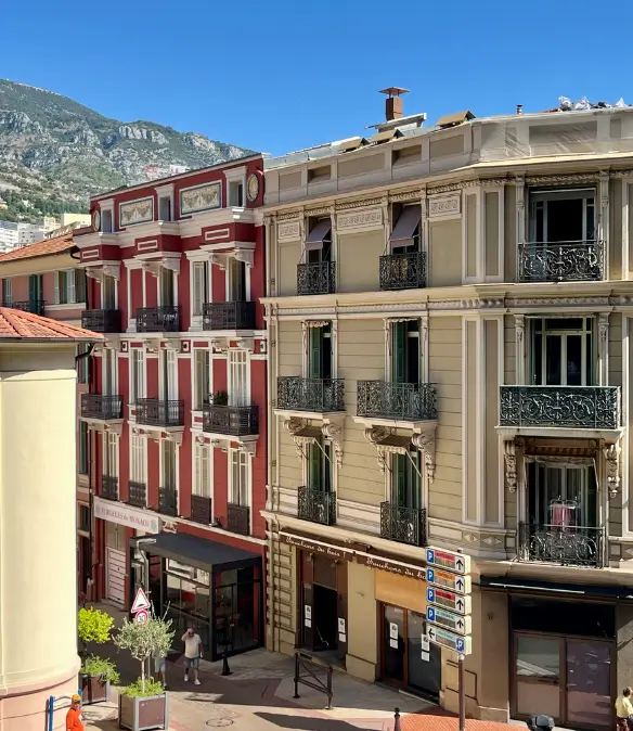 A street in Monaco with colourful luxury residential and commercial buildings