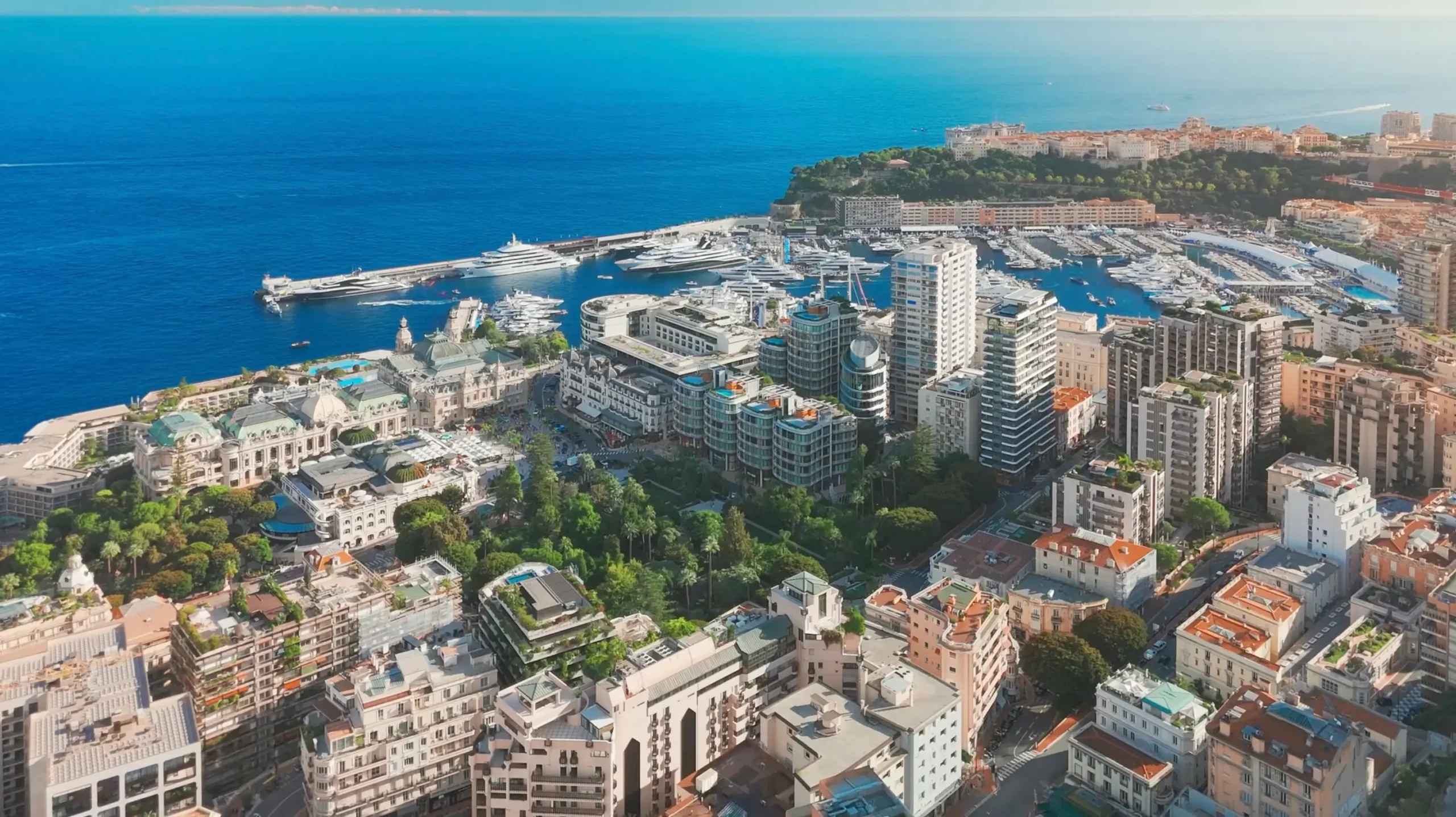 An aerial image of the Monaco casino square, its surroundings in Monte Carlo, and the Mediterranean sea.